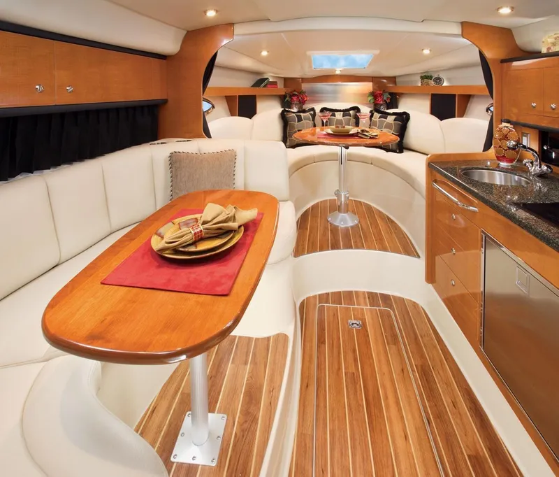Slide: The Image of Luxurious interior of 2008 Chaparral 310 Signature yacht with elegant wood finishes and plush seating. - 21