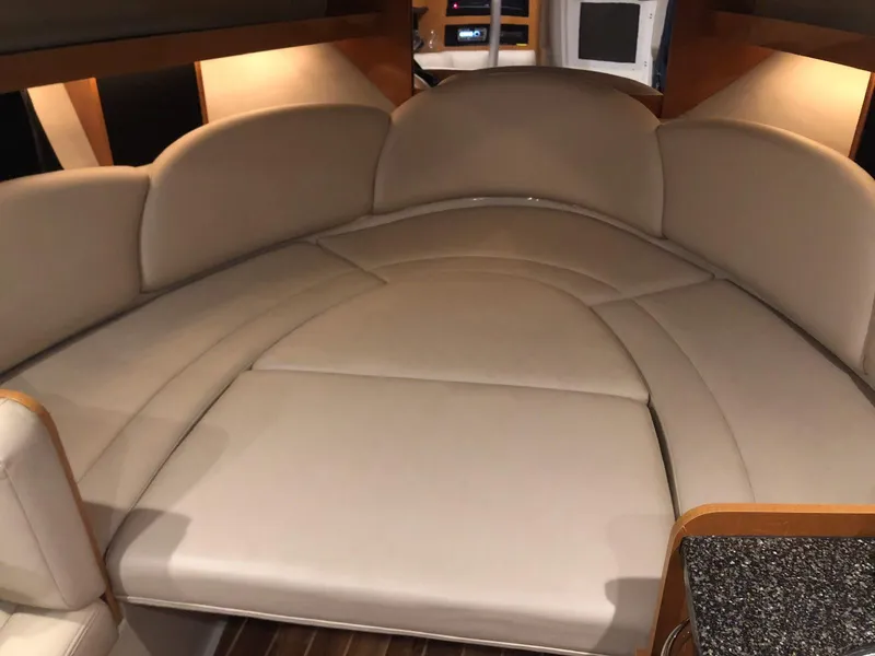 Slide: The Image of 2008 Chaparral 310 Signature interior with beige seating and wood accents. - 22