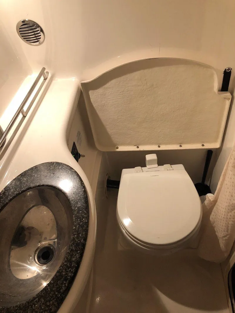 Slide: The Image of 2008 Chaparral 310 Signature boat bathroom with sink and toilet. - 25