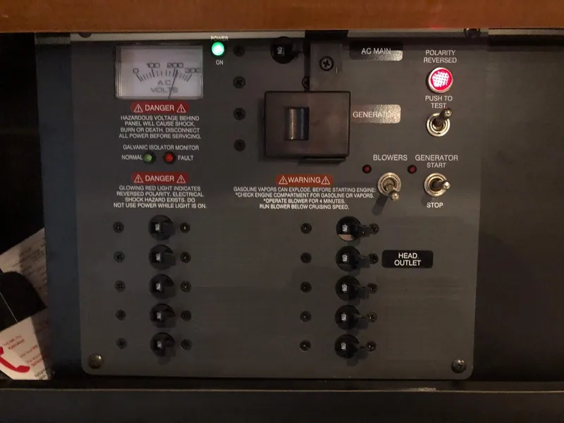 Slide: The Image of Control panel of a 2008 Chaparral 310 Signature boat with various switches and warning labels. - 26