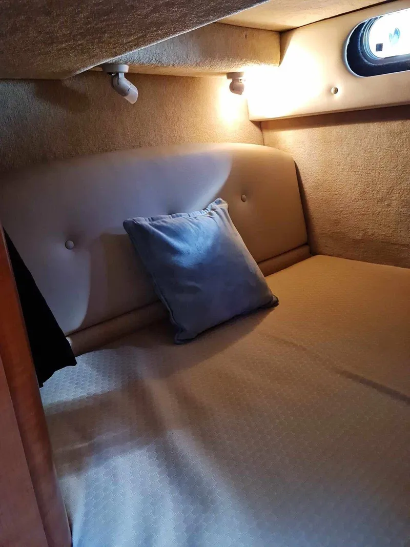 Slide: The Image of 2008 Chaparral 310 Signature cabin interior with cozy bed and soft lighting. - 27