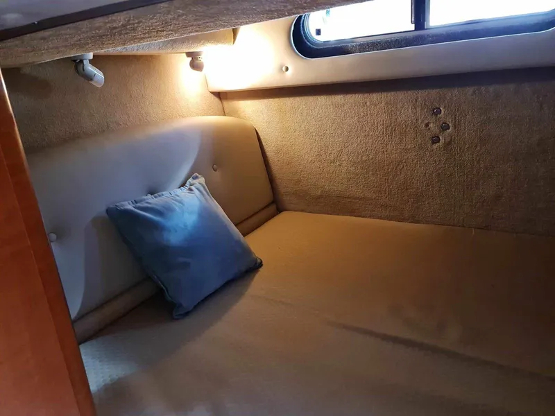 Slide: The Image of 2008 Chaparral 310 Signature cabin interior with cozy bed and soft lighting. - 28