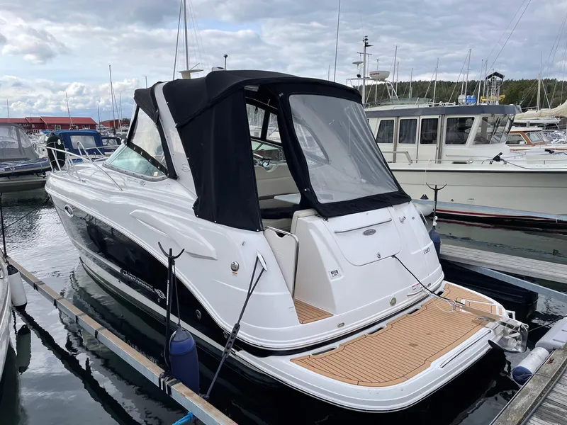 Slide: The Image of 2008 Chaparral 310 Signature boat docked at marina, featuring sleek design and black canopy. - 3