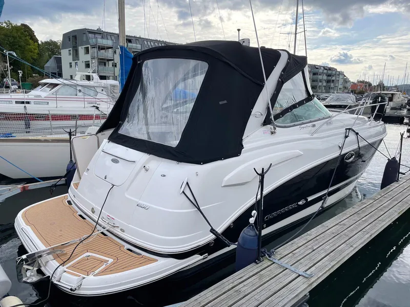 Slide: The Image of 2008 Chaparral 310 Signature boat docked at marina with black canopy. - 4