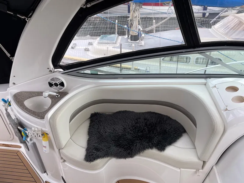 Slide: The Image of 2008 Chaparral 310 Signature boat interior with white seating, black cushion, and compact sink. - 6