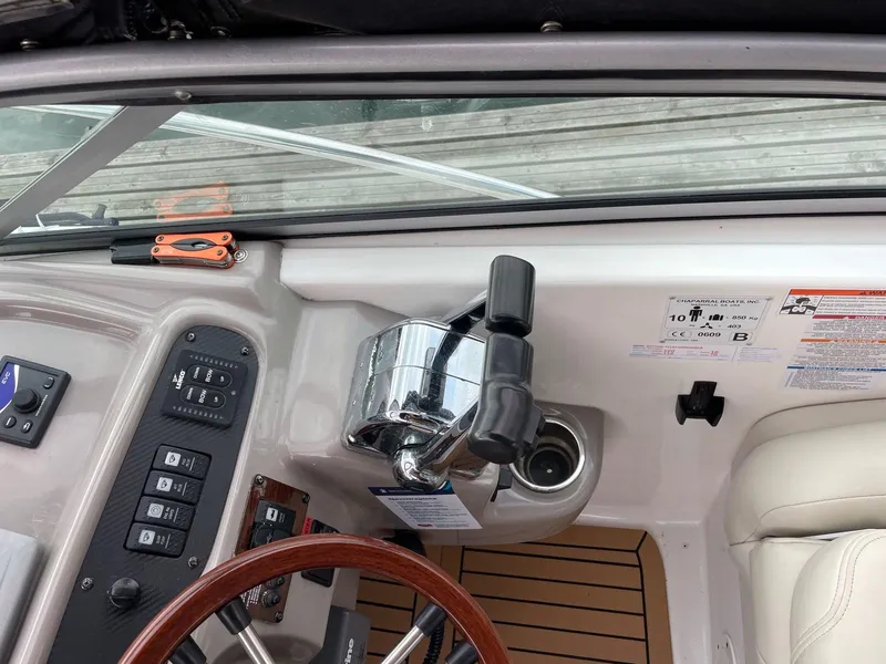 Slide: The Image of 2008 Chaparral 310 Signature boat cockpit with controls and steering wheel. - 9