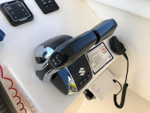 Slide: The Image of Control panel of 2022 May-Craft 2700 Pilot House boat with Suzuki throttle. - 12