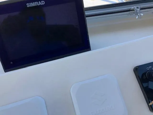 Slide: The Image of Simrad display and controls on 2022 May-Craft 2700 Pilot House boat dashboard. - 15