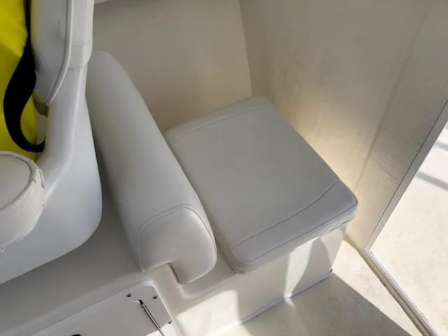 Slide: The Image of 2022 May-Craft 2700 Pilot House interior seat with white upholstery. - 19