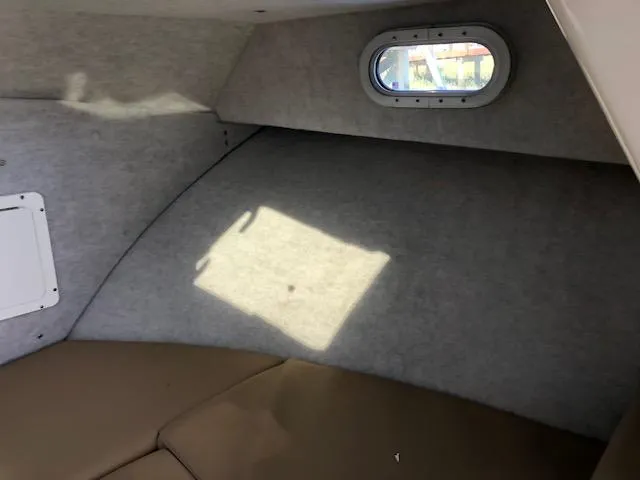 Slide: The Image of Interior cabin of 2022 May-Craft 2700 Pilot House with window and seating. - 22