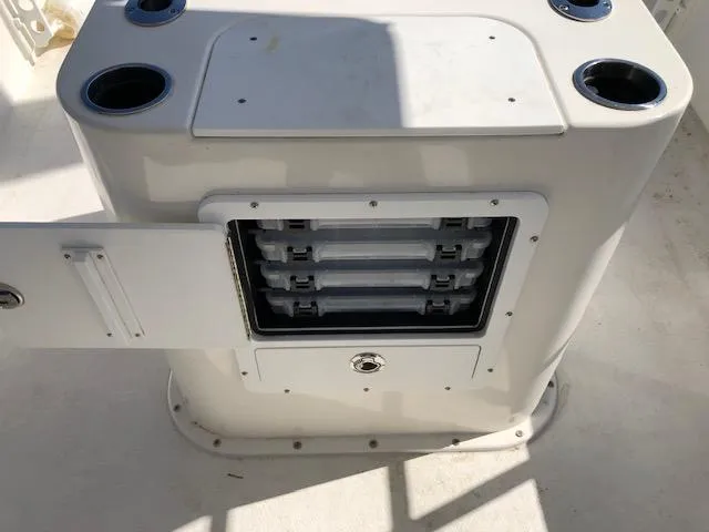 Slide: The Image of 2022 May-Craft 2700 Pilot House storage compartment with open door and tackle trays. - 26