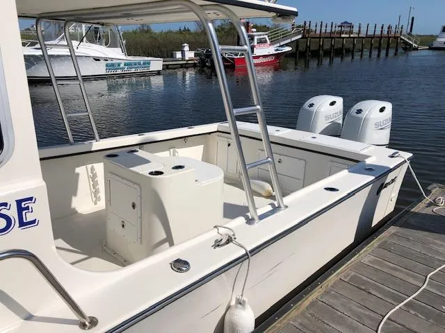 Slide: The Image of 2022 May-Craft 2700 Pilot House boat docked with twin Suzuki engines. - 3