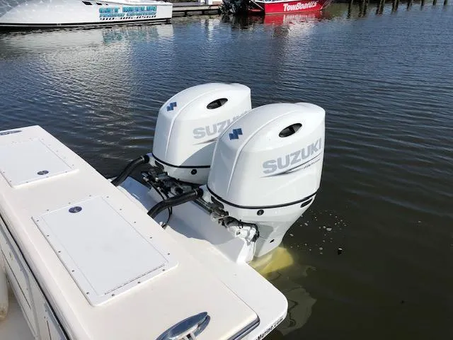 Slide: The Image of Twin Suzuki outboard motors on a 2022 May-Craft 2700 Pilot House boat. - 4