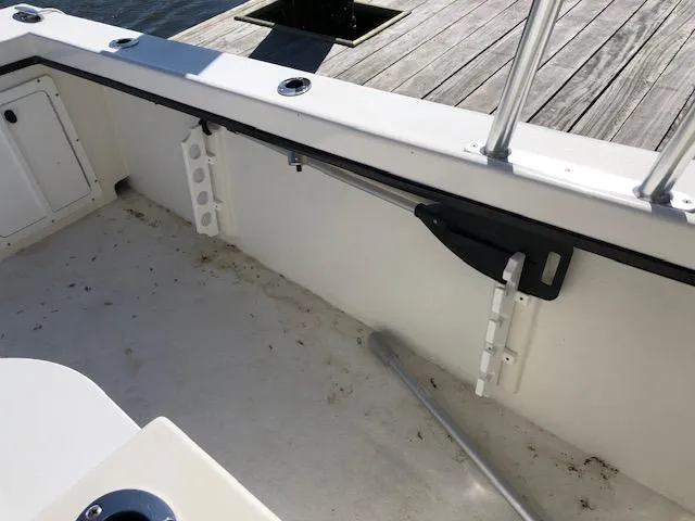 Slide: The Image of 2022 May-Craft 2700 Pilot House interior, showcasing clean deck and rod holder. - 8