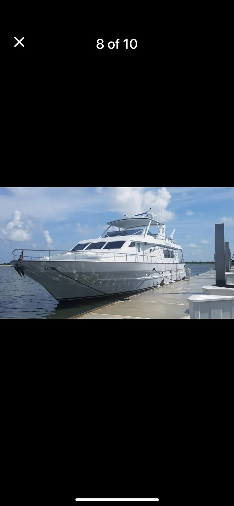 Slide: The Image of 1997 Tarrab Motor Yacht docked by the water under a clear blue sky. - 10