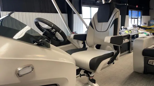 Slide: The Image of 2025 Tahoe LTZ 2385 VRL boat interior with steering wheel and captain's chair. - 12