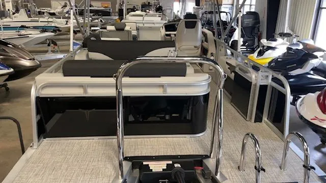 Slide: The Image of 2025 Tahoe LTZ 2385 VRL pontoon boat displayed in a showroom with other watercraft. - 5