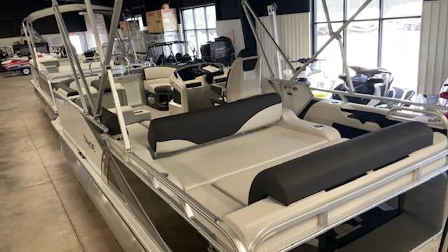 Slide: The Image of 2025 Tahoe LTZ 2385 VRL pontoon boat with spacious seating in a showroom. - 6