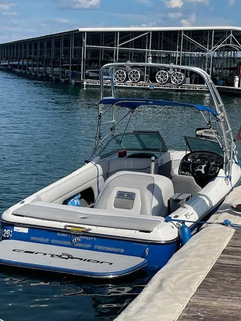 Slide: The Image of 2007 Ski Centurion T-5 Competition boat docked at marina, featuring sleek design and wakeboard tower. - 0