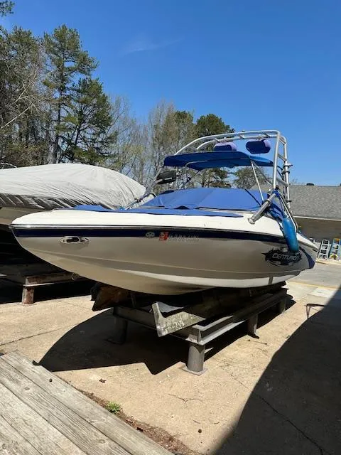 Slide: The Image of 2007 Ski Centurion T-5 Competition boat on a stand, blue canopy, outdoor setting. - 3