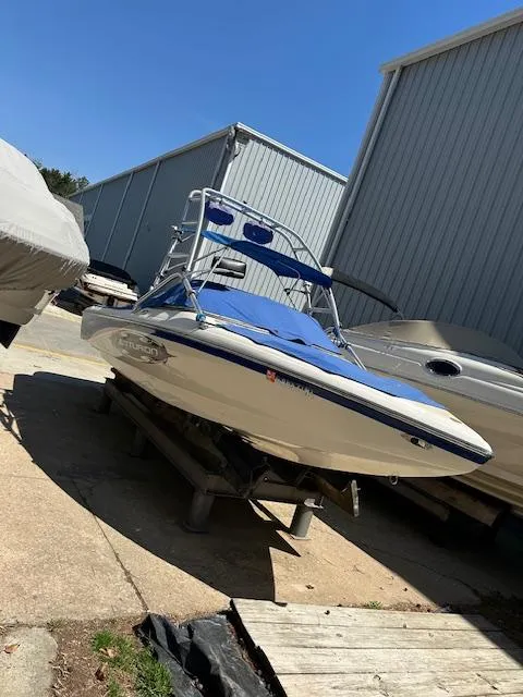 Slide: The Image of 2007 Ski Centurion T-5 Competition boat in storage, blue and white exterior, sunny day. - 5