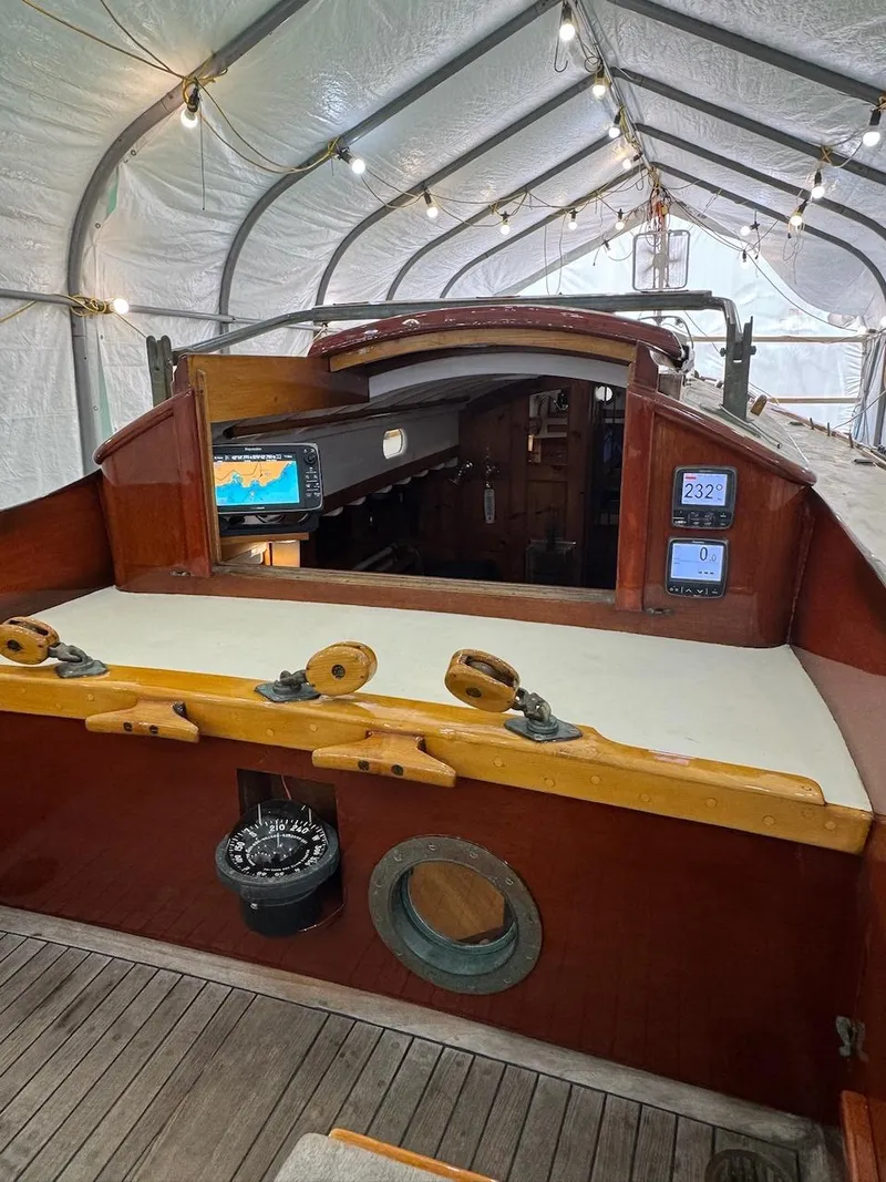 Slide: The Image of 1955 Concordia 39 Yawl interior with navigation equipment, under a protective canopy. - 10