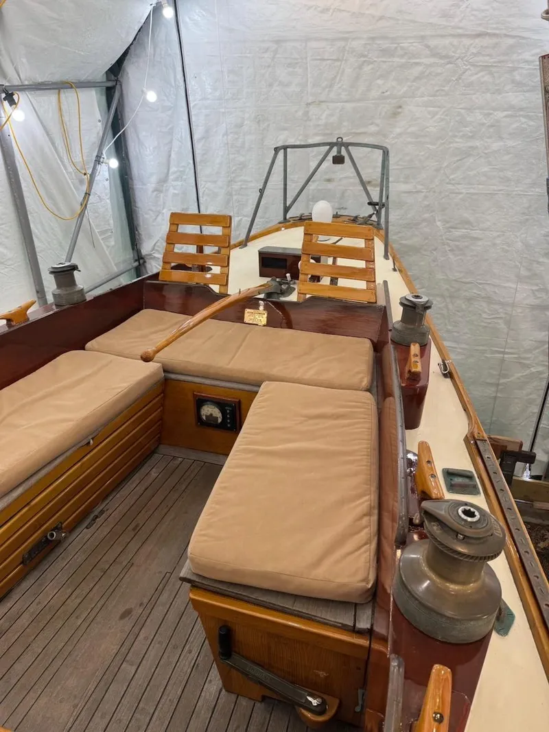 Slide: The Image of 1955 Concordia 39 Yawl interior with wooden seating and nautical equipment. - 16