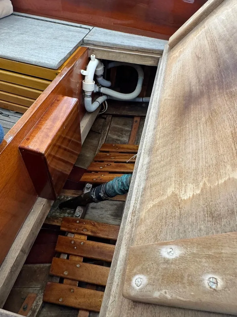 Slide: The Image of Interior view of a 1955 Concordia 39 Yawl sailboat, showcasing wooden craftsmanship and plumbing. - 19