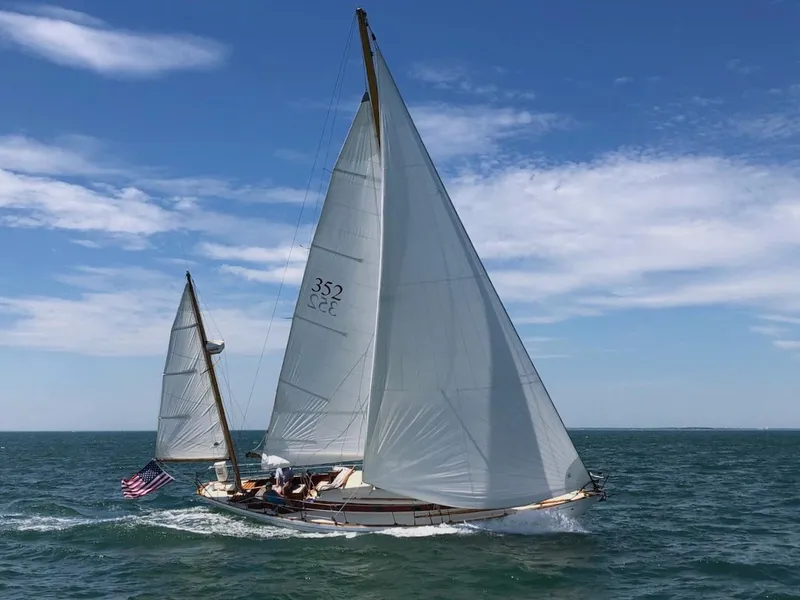 Slide: The Image of 1955 Concordia 39 Yawl sailing on open sea under clear blue sky. - 2