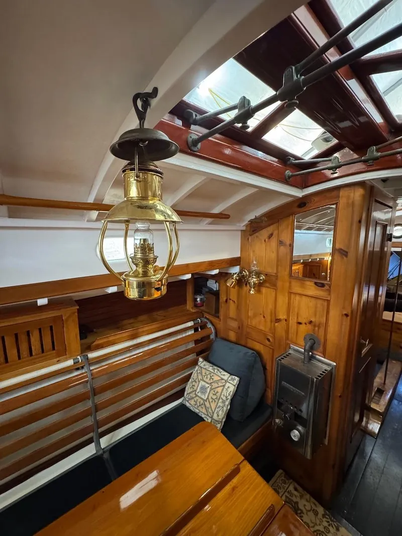 Slide: The Image of Interior of a 1955 Concordia 39 Yawl with wooden furnishings and brass lantern. - 22
