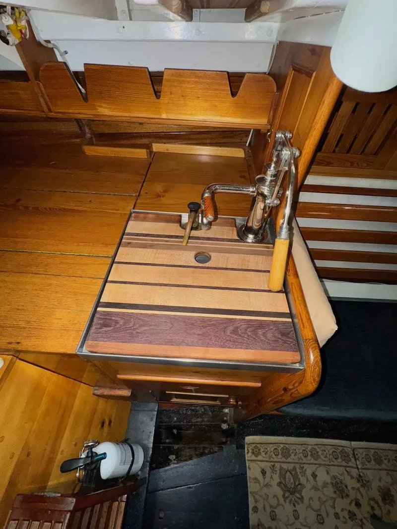 Slide: The Image of 1955 Concordia 39 Yawl interior with wooden cabinetry and vintage sink. - 28