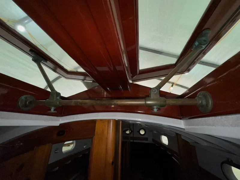 Slide: The Image of Interior view of a 1955 Concordia 39 Yawl sailboat, showcasing wooden and metal fittings. - 32