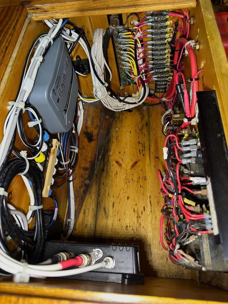 Slide: The Image of Electrical wiring inside a 1955 Concordia 39 Yawl, showcasing organized cables and connections. - 34