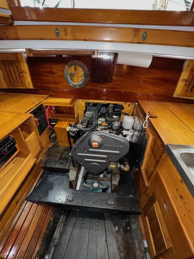 Slide: The Image of Engine room of a 1955 Concordia 39 Yawl with wooden interior and visible engine. - 35