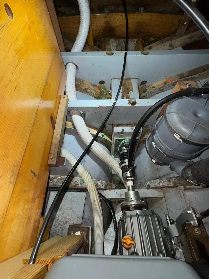Slide: The Image of Engine compartment of a 1955 Concordia 39 Yawl, showing mechanical components and wiring. - 36