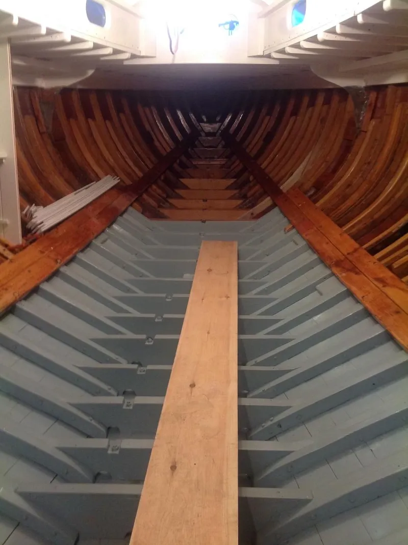 Slide: The Image of Interior view of 1955 Concordia 39 Yawl, showcasing wooden framework and structure. - 43