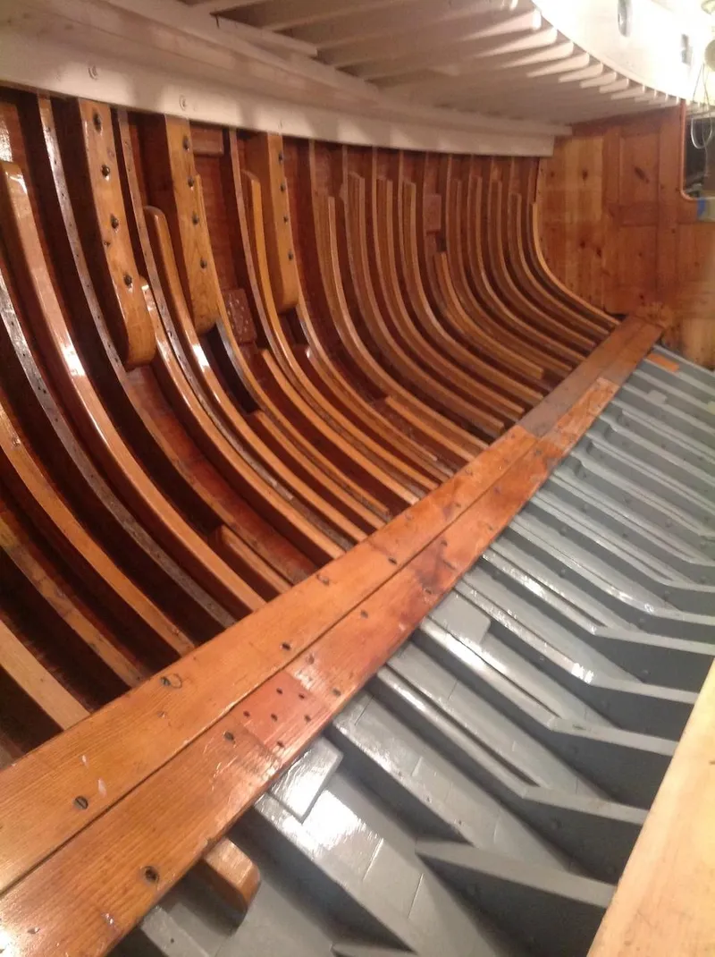 Slide: The Image of Interior view of 1955 Concordia 39 Yawl, showcasing wooden craftsmanship and structural design. - 44