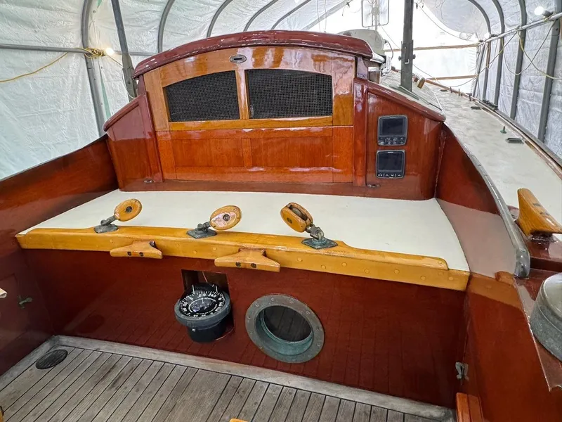 Slide: The Image of 1955 Concordia 39 Yawl cockpit with wooden finish and navigation instruments. - 9