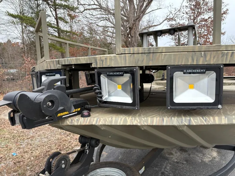 Slide: The Image of 2018 Tracker GRIZZLY 2072 SPORTSMAN boat with mounted lights and trolling motor, outdoors. - 11