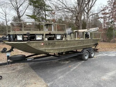 Slide: The Image of 2018 Tracker GRIZZLY 2072 SPORTSMAN boat on trailer, parked outdoors in wooded area. - 3