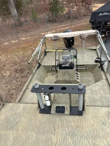 Slide: The Image of 2018 Tracker GRIZZLY 2072 SPORTSMAN boat with fishing rod holders and motor, outdoors. - 5