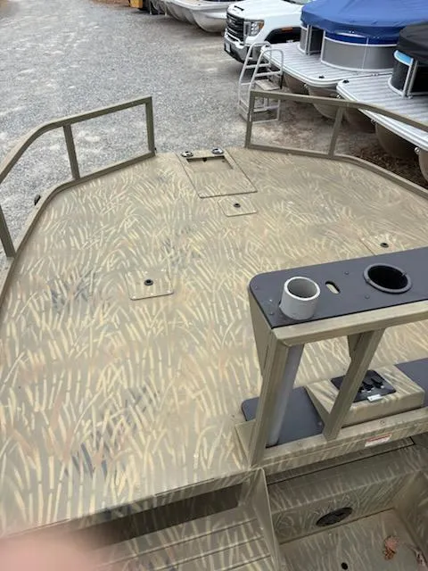 Slide: The Image of 2018 Tracker GRIZZLY 2072 SPORTSMAN boat deck with camouflage pattern, docked near other boats. - 6