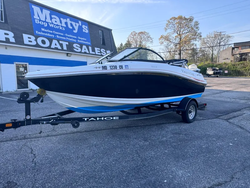 The Image of 2022 Tahoe 185 S boat on trailer at Marty's Boat Sales parking lot. - 0