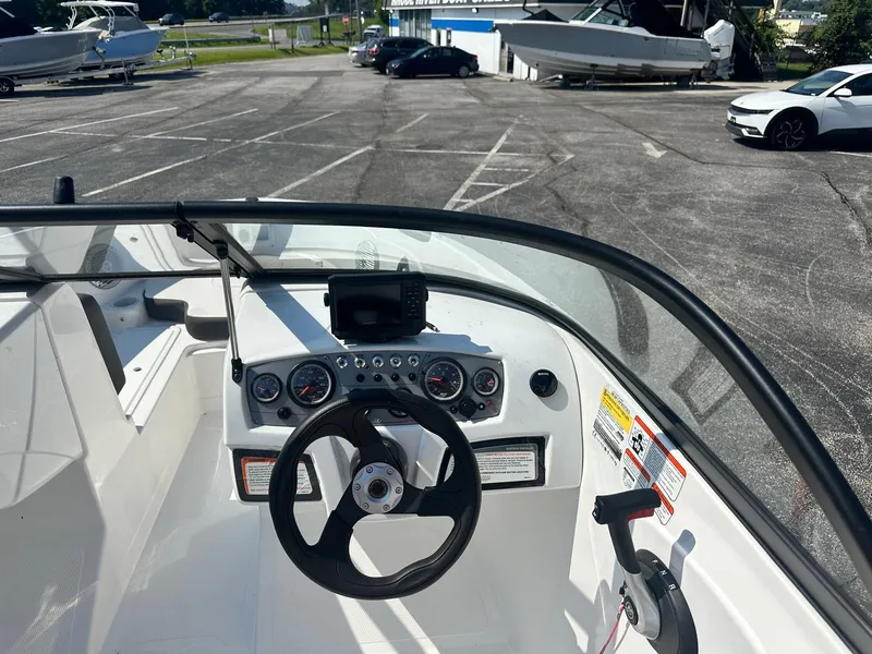 Slide: The Image of Cockpit view of 2022 Tahoe 185 S boat in a parking lot. - 10