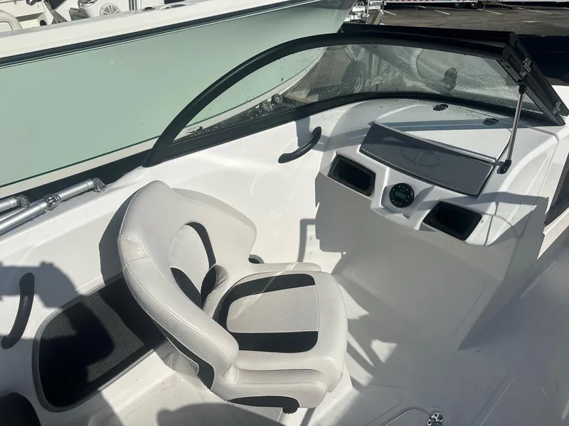 Slide: The Image of 2022 Tahoe 185 S boat interior with steering wheel and seating. - 12
