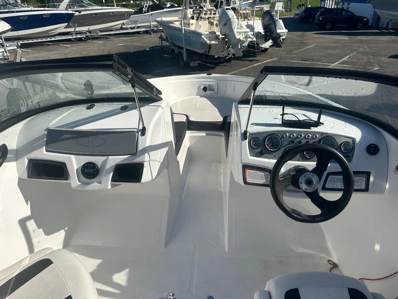 Slide: The Image of 2022 Tahoe 185 S boat interior with steering wheel and dashboard controls. - 14