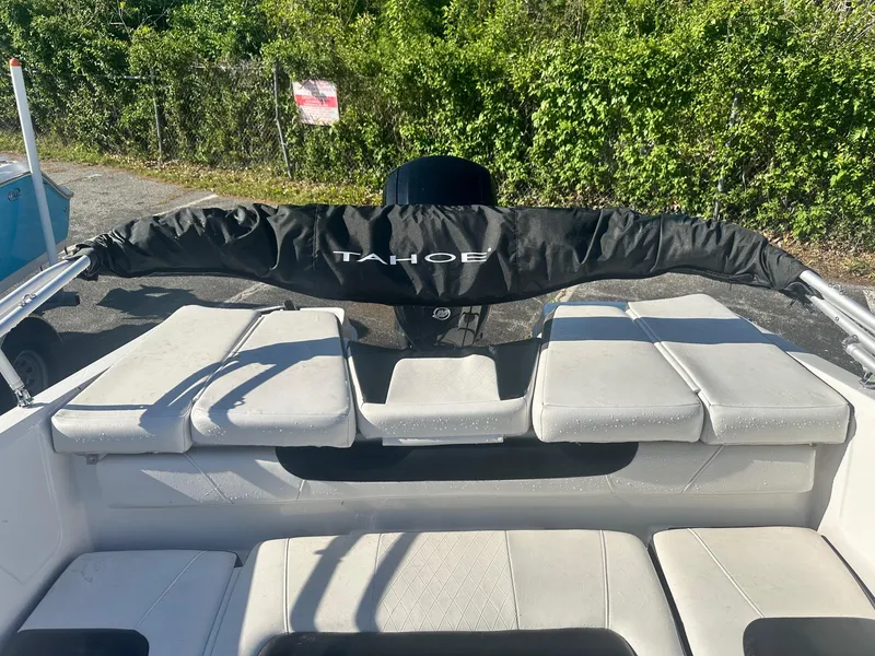 Slide: The Image of 2022 Tahoe 185 S boat interior with cushioned seating and protective cover. - 16