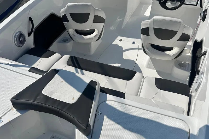 Slide: The Image of 2022 Tahoe 185 S boat interior with white and black seating and steering wheel. - 30