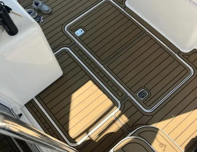 Slide: The Image of 2005 Silverton 34 Convertible boat deck with teak flooring and storage hatches. - 3