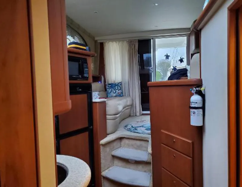 Slide: The Image of Interior of 2005 Silverton 34 Convertible yacht, featuring cozy seating and modern amenities. - 7